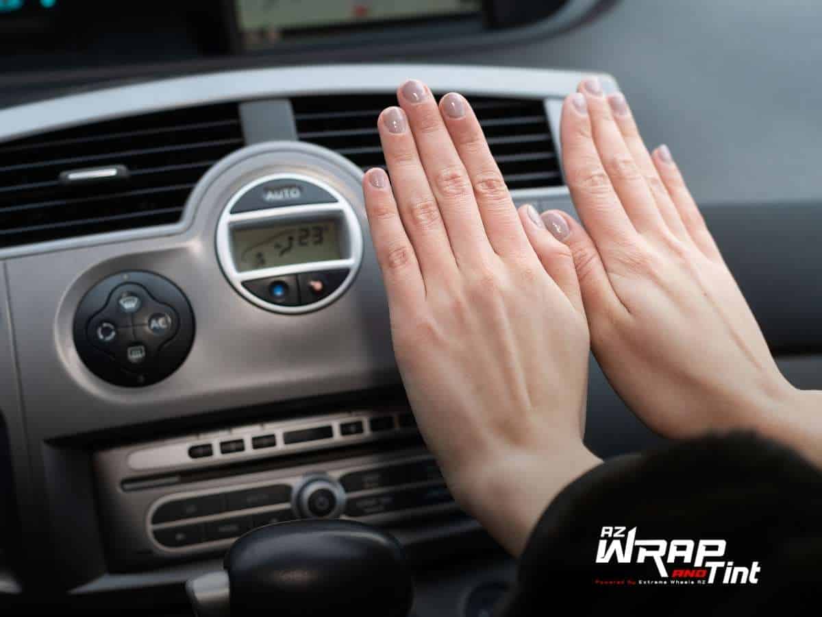 female refreshing her hands with her car's AC